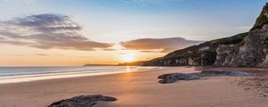 Preview wallpaper beach, stones, rocks, sun, rays, sea