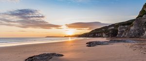 Preview wallpaper beach, stones, rocks, sun, rays, sea