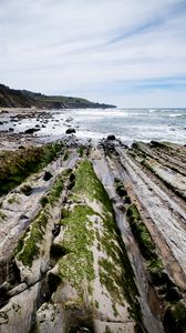 Preview wallpaper beach, stones, trees, mountains, sea, horizon, landscape