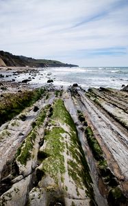 Preview wallpaper beach, stones, trees, mountains, sea, horizon, landscape
