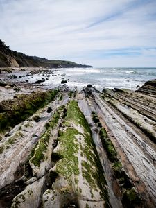 Preview wallpaper beach, stones, trees, mountains, sea, horizon, landscape