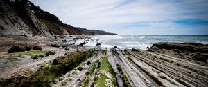Preview wallpaper beach, stones, trees, mountains, sea, horizon, landscape