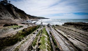 Preview wallpaper beach, stones, trees, mountains, sea, horizon, landscape