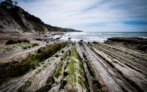 Preview wallpaper beach, stones, trees, mountains, sea, horizon, landscape