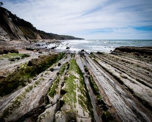 Preview wallpaper beach, stones, trees, mountains, sea, horizon, landscape