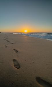 Preview wallpaper beach, sunset, footprints, sand