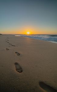 Preview wallpaper beach, sunset, footprints, sand