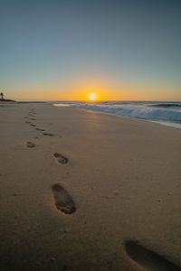 Preview wallpaper beach, sunset, footprints, sand