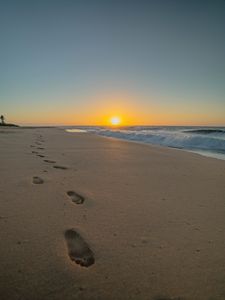 Preview wallpaper beach, sunset, footprints, sand