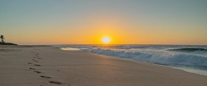 Preview wallpaper beach, sunset, footprints, sand