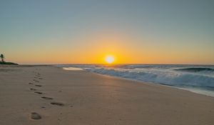 Preview wallpaper beach, sunset, footprints, sand