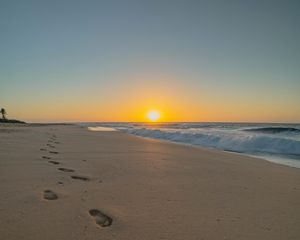 Preview wallpaper beach, sunset, footprints, sand