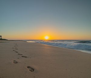 Preview wallpaper beach, sunset, footprints, sand