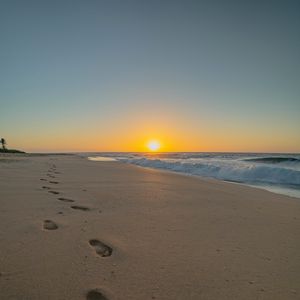 Preview wallpaper beach, sunset, footprints, sand