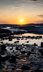 Preview wallpaper beach, sunset, water, stones, sand, sea, dusk