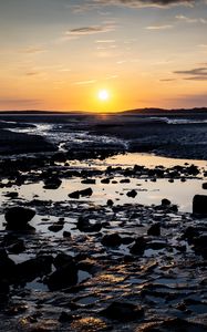 Preview wallpaper beach, sunset, water, stones, sand, sea, dusk