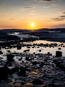 Preview wallpaper beach, sunset, water, stones, sand, sea, dusk