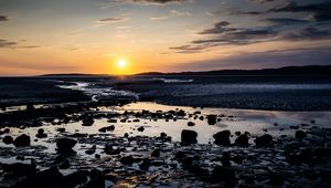 Preview wallpaper beach, sunset, water, stones, sand, sea, dusk
