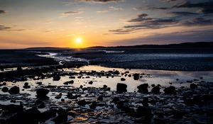 Preview wallpaper beach, sunset, water, stones, sand, sea, dusk