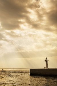 Preview wallpaper beacon, beams, sun, water, sea, sky