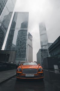 Preview wallpaper bentley continental gt, bentley, car, orange, front view, city, buildings