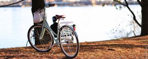 Preview wallpaper bicycle, autumn, trees, foliage, river