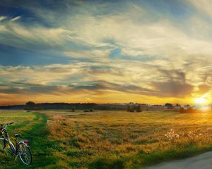 Preview wallpaper bicycle, field, clouds, silence, evening, decline, sky