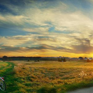 Preview wallpaper bicycle, field, clouds, silence, evening, decline, sky