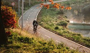 Preview wallpaper bicycle, man, helmet, road, trees