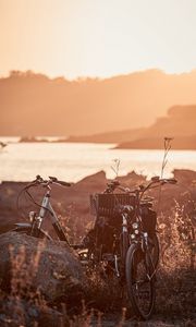 Preview wallpaper bicycle, walk, stone, lake, sunset