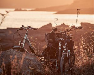 Preview wallpaper bicycle, walk, stone, lake, sunset