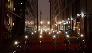 Preview wallpaper bicycles, constructions, road, lights, buildings, night