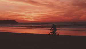 Preview wallpaper bicyclist, sea, shore, sunset