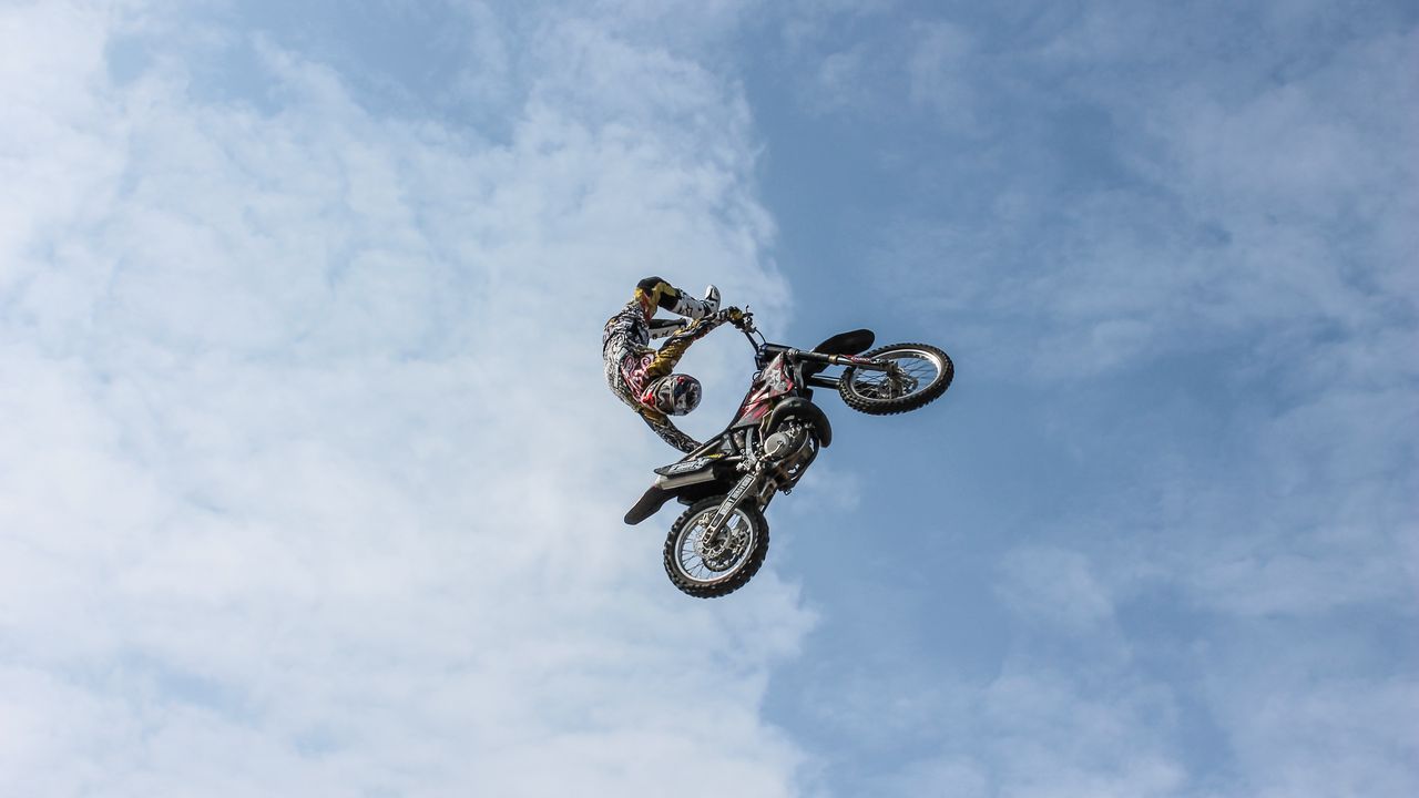 Wallpaper biker, motorcycle, extreme, trick, clouds, sky