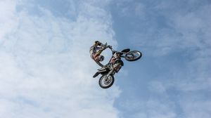 Preview wallpaper biker, motorcycle, extreme, trick, clouds, sky