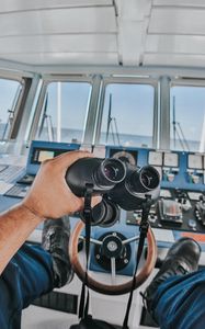 Preview wallpaper binoculars, hand, steering wheel, ship, control