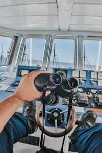 Preview wallpaper binoculars, hand, steering wheel, ship, control