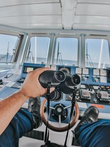 Preview wallpaper binoculars, hand, steering wheel, ship, control