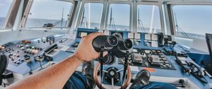 Preview wallpaper binoculars, hand, steering wheel, ship, control