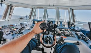 Preview wallpaper binoculars, hand, steering wheel, ship, control