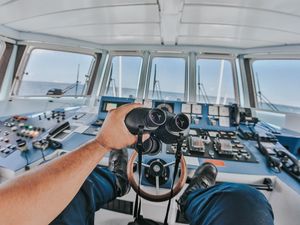 Preview wallpaper binoculars, hand, steering wheel, ship, control