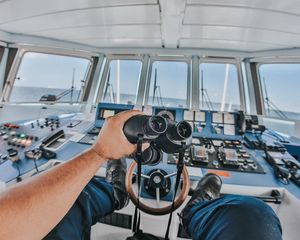 Preview wallpaper binoculars, hand, steering wheel, ship, control