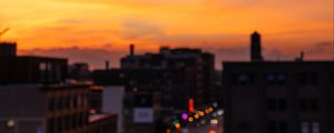 Preview wallpaper blur, city, glare, sunset, buildings