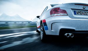 Preview wallpaper bmw 1-series m coupe, bmw, car, white, wet, rear view, speed