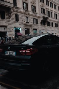 Preview wallpaper bmw, black, rear view, city