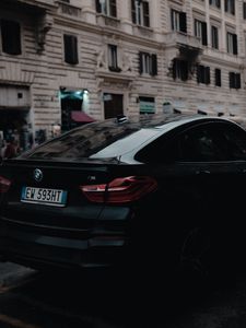 Preview wallpaper bmw, black, rear view, city