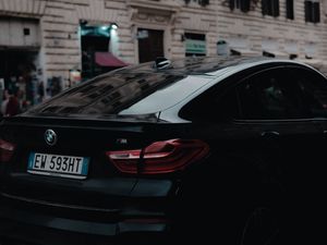 Preview wallpaper bmw, black, rear view, city