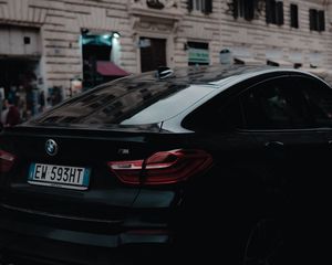 Preview wallpaper bmw, black, rear view, city