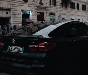 Preview wallpaper bmw, black, rear view, city