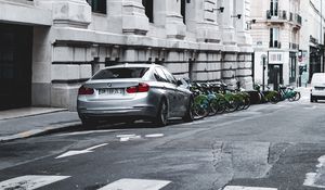 Preview wallpaper bmw, car, gray, parking, road, buildings